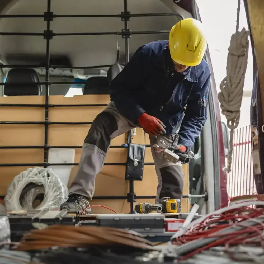 Landscaper grabbing tools inside their vehicle