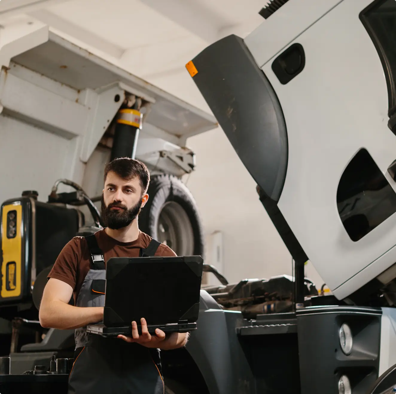 Mechanic reviewing diagnostics on laptop