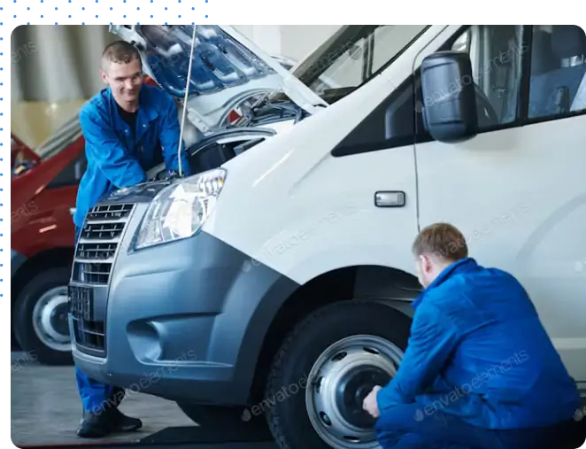 Technicians performing vehicle maintenance