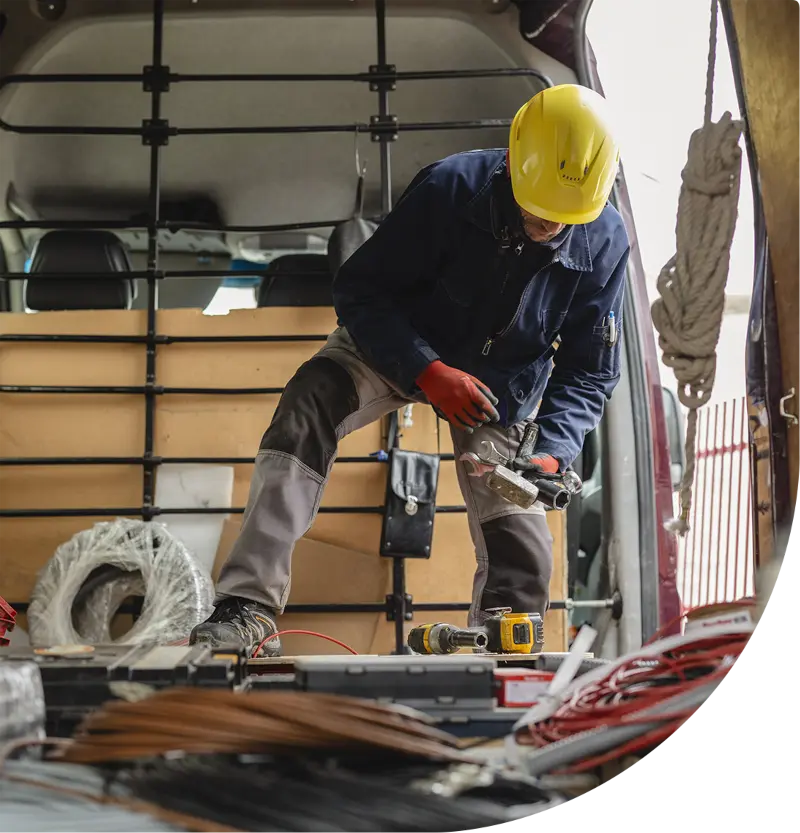 Landscaper grabbing tools inside their vehicle