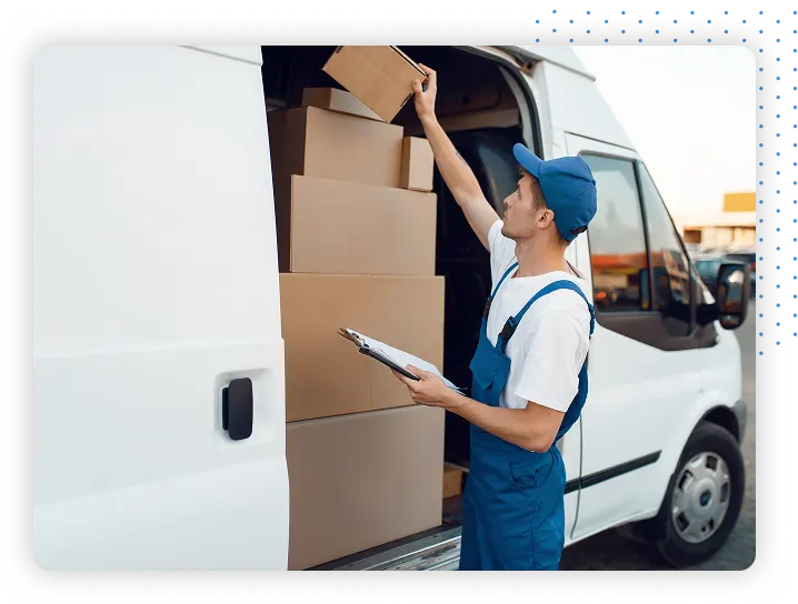Man with clipboard loading boxes into white van